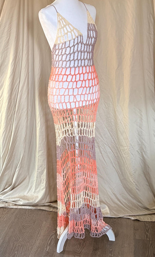 Mannequin wearing a colorful crochet dress against a plain background